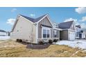 Side view of a charming craftsman style home with gray siding and stone accents at 7098 Sterling Way, Brownsburg, IN 46112