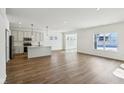 Open concept kitchen with an island, stainless steel appliances, and light cabinets at 7098 Sterling Way, Brownsburg, IN 46112