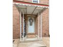 Brick front entrance with a covered porch and welcoming decor at 383 Carmelaire Ct, Carmel, IN 46032