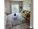 Comfortable living room with sliding glass doors to the backyard and stylish rug at 383 Carmelaire Ct, Carmel, IN 46032
