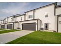 The back exterior shows the garage and door access with freshly cut grass at 6227 Rhinecliff Dr, Whitestown, IN 46075