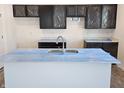 Modern kitchen with dark cabinetry, quartz countertops, and an island at 6272 Granby Dr, Whitestown, IN 46075