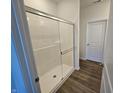 Modern bathroom shower with glass doors and sleek design, enhancing a bright and clean space at 6296 Granby Dr, Whitestown, IN 46075