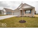 Well-maintained one-story home showcasing a three-car garage, neat landscaping, and classic architectural style at 6322 Granby Dr, Whitestown, IN 46075