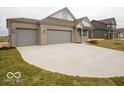 Attractive ranch-style home with a spacious driveway and three-car garage, nestled in a serene neighborhood at 6322 Granby Dr, Whitestown, IN 46075
