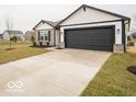 Charming single-story home showcasing a two-car garage and well-maintained front lawn at 6623 Sulgrove Pl, Indianapolis, IN 46221
