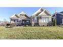 House exterior showcasing stone and siding with a well-maintained lawn at 12535 Tidecrest Dr, Fishers, IN 46037