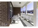 Inviting covered porch with white railings, offering a relaxing space for outdoor seating at 4326 Switchgrass Way, Indianapolis, IN 46237