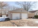 Double-car garage with white doors and tan siding at 3359 Laurel St, Indianapolis, IN 46227
