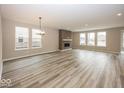 Spacious living room with hardwood floors, a modern fireplace, and plenty of natural light at 19955 Boulder Brook Ln, Westfield, IN 46074
