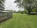 Expansive backyard featuring a large grassy area with mature trees and shelter, perfect for outdoor activities at 8418 S State Road 39, Clayton, IN 46118