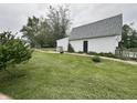 Private backyard featuring a detached garage, well-maintained lawn and partial fence, ideal for recreation at 8418 S State Road 39, Clayton, IN 46118