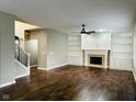 Cozy living room with fireplace, built-in shelves, and hardwood floors, perfect for relaxing at 14914 Annabel Ct, Westfield, IN 46074