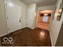 Bright entryway with parquet flooring and view to dining room at 7317 Lions Head Dr # 2, Indianapolis, IN 46260