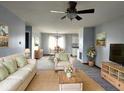 Bright living room features neutral colors, comfy seating, and a view into the dining area at 1425 Lawrence Way, Anderson, IN 46013