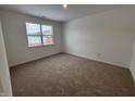 Bright bedroom featuring neutral carpeting and a large window at 5226 Woodhurst Ln, Indianapolis, IN 46239