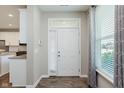 Inviting foyer with natural light, wood floors, and a view to the kitchen, creating a warm welcome at 17345 Northam Dr, Westfield, IN 46074
