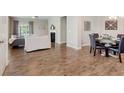 Open-concept living and dining area with hardwood floors and a cozy fireplace, great for gatherings at 17345 Northam Dr, Westfield, IN 46074
