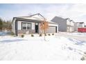 Two-story home with gray garage and snowy landscaping at 5127 Cartland Dr, Indianapolis, IN 46239