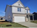 Handsome two-story home featuring gray siding, brick facade, covered porch, and a pristine front yard at 6196 Granby Dr, Whitestown, IN 46075