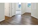 Light and airy entryway with wood-look floors and doors to other rooms at 155 Maxim Ct # 093-B, Cumberland, IN 46229