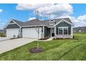 Gray siding home with white trim and landscaping at 155 Maxim Ct # 093-B, Cumberland, IN 46229