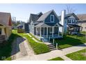 Aerial view of a gray craftsman home and surrounding houses at 560 Jefferson Ave, Indianapolis, IN 46201
