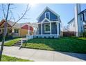 Gray craftsman home with white porch, steps, and landscaping at 560 Jefferson Ave, Indianapolis, IN 46201