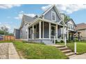 Home exterior featuring a covered porch with steps and a sidewalk leading to the front entrance at 560 Jefferson Ave, Indianapolis, IN 46201