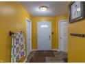 Bright entryway with yellow walls and wood-look floors at 7209 Bean Blossom Rd, Morgantown, IN 46160
