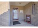 Inviting front porch with a charming bench and wind chimes at 7209 Bean Blossom Rd, Morgantown, IN 46160