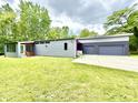 Well-maintained exterior of a modern home with green lawn and two car garage at 7650 Clarion Dr, Indianapolis, IN 46236