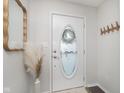 Bright entryway featuring a white front door with oval window and coat hooks at 10656 Adam Ct, Fishers, IN 46037