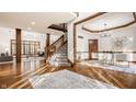 Open-concept living room with hardwood floors, staircase, and ample natural light at 1462 Eagle Trace Ct, Greenwood, IN 46143