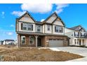 Charming two-story home with a brick and vinyl exterior and a three-car garage on a sunny day at 20326 N Pacific Ave, Westfield, IN 46074