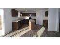 Modern kitchen with dark brown cabinets, stainless steel appliances, and an island at 3912 Highcrest Rd, Indianapolis, IN 46239