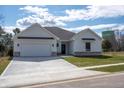 Charming single-story home with white siding, a gray roof, and an attached garage in a tranquil location at 5143 Oak Ridge Pl, Columbus, IN 47201