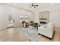 Bright living room featuring a modern fireplace, vaulted ceilings, stylish furniture, and natural light from large windows at 5143 Oak Ridge Pl, Columbus, IN 47201