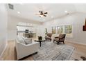 Open-concept living room with neutral decor, a view of the kitchen, and ample seating for entertaining guests at 5143 Oak Ridge Pl, Columbus, IN 47201