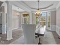 Inviting dining area with hardwood floors, large windows, and stylish chandelier at 10346 Strongbow Rd, Fishers, IN 46040