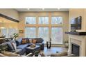 Open living space with a sectional sofa, fireplace, and wall of windows at 1372 N Stoney Brook, Greenfield, IN 46140