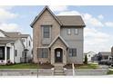 Charming two-story home with gray brick and siding, a covered entryway, and manicured landscaping at 1667 Midland Main St, Westfield, IN 46074