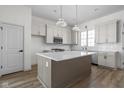Modern kitchen with white cabinets, quartz countertops, and an island at 1667 Midland Main St, Westfield, IN 46074