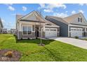 Inviting home boasts a two-car garage, well-kept lawn, and appealing architectural details at 16946 Cattle Hollow Ln, Noblesville, IN 46060