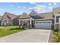 Attractive home features a well-maintained lawn, concrete driveway, and a welcoming exterior design at 16946 Cattle Hollow Ln, Noblesville, IN 46060