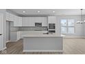 Modern kitchen features white cabinets, quartz countertops, stainless steel appliances, and center island at 16946 Cattle Hollow Ln, Noblesville, IN 46060
