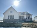 Stylish two-story home with white siding, stone accents, and a charming front entry at 19566 Wood Farm Pl, Westfield, IN 46074