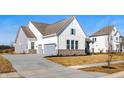 Beautiful two-story home with a two car garage, stone base, and a sidewalk at 19566 Wood Farm Pl, Westfield, IN 46074