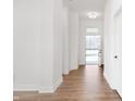 Bright and inviting hallway with hardwood floors, white walls, and a front door at 19566 Wood Farm Pl, Westfield, IN 46074