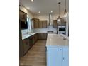 Modern kitchen with stainless steel appliances, a large island, and wooden cabinets at 19566 Wood Farm Pl, Westfield, IN 46074